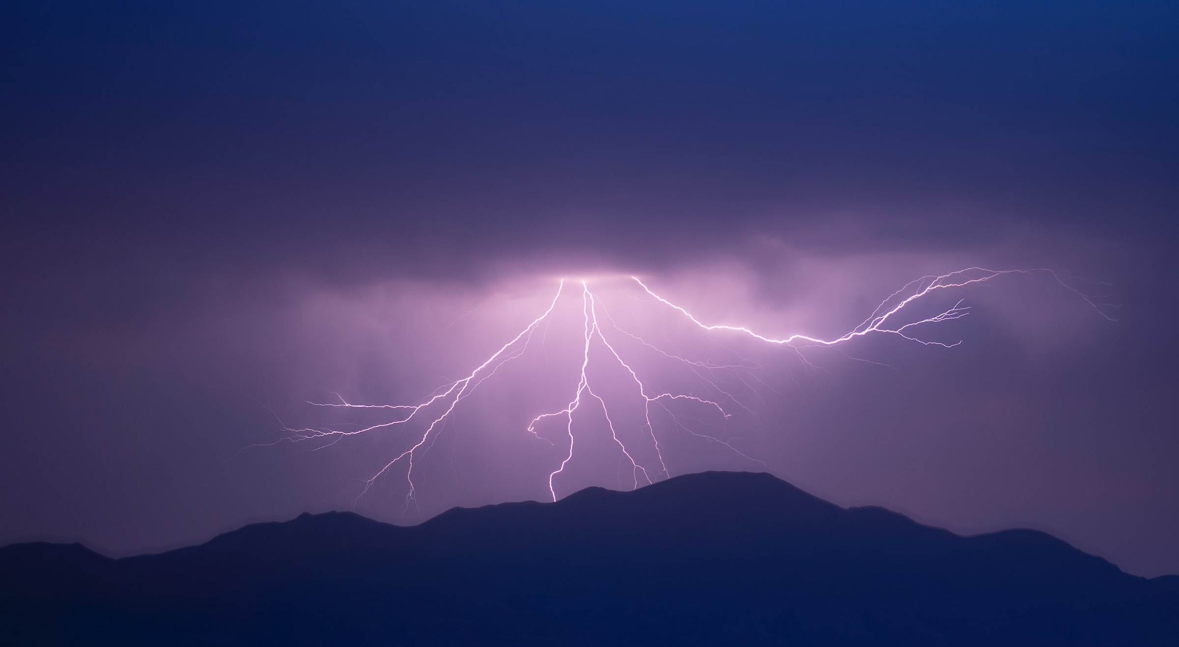 Image showing lightning strikes over mountains